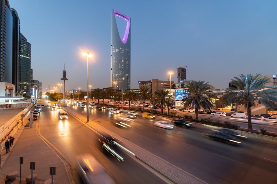 Traffic on the main avenue crossing the modern business and downtown district of Riyadh at sunset in Saudi Arabia capital city.