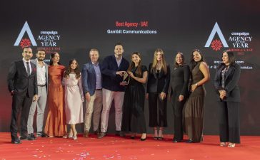 The Gambit Communications team were all smiles on stage after receiving the Best Agency - UAE trophy, handed over by category partner, Banan Abu Si a, Commercial Director, Private Jet Media (R).