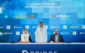 From left, Maitha Al Suwaidi, CEO of Strategy and Media Policies Sector, UAE Media Council; Mohammed Saeed Al Shehhi, Secretary-General of the UAE Media Council (standing); and Mike Alnaji, CEO, Imfluence. ink an MoU for the Visitors Advertiser Permit