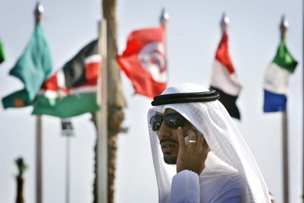 An Arab media representative talks on his mobile phone outside the congress center where the 15th summit of the Non-Aligned Movement (NAM) in the resort town of Sharm El-Sheikh is held on July 15, 2009. Developing world leaders gather in Egypt to discuss the effect the global financial crisis has had on their countries. Cuban President Raul Castro addressed the opening session of the two-day summit where Egypt will take over the chairmanship from Cuba. AFP PHOTO/KHALED DESOUKI (Photo credit should read KHALED DESOUKI/AFP/Getty Images)