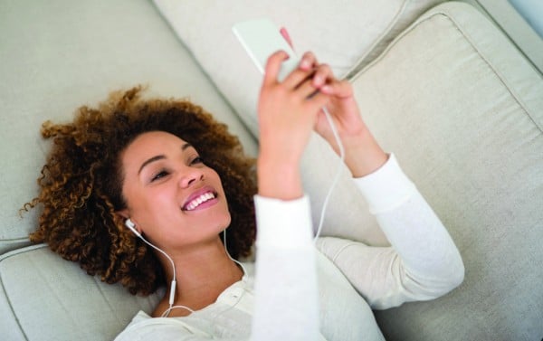 Young woman listening to music at home